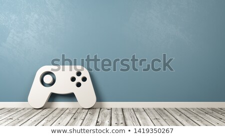 Stok fotoğraf: Gamepad Controller Symbol On Wooden Floor Against Wall