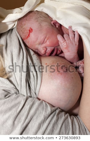 Stock photo: Laying Of A Newborn Baby To The Breast After Birth