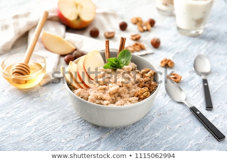 Foto d'archivio: Spoon Of Oatmeal Porridge With Apples And Walnuts