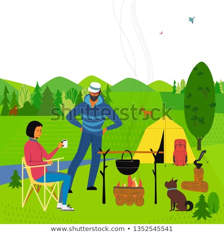 Foto stock: Couple At Campsite Cooking Hot Dogs