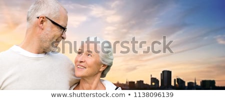 ストックフォト: Senior Couple Hugging Over Evening Tallinn City
