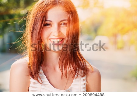 Zdjęcia stock: Portrait Of Redhead Young Woman Smiling With Sun Flare