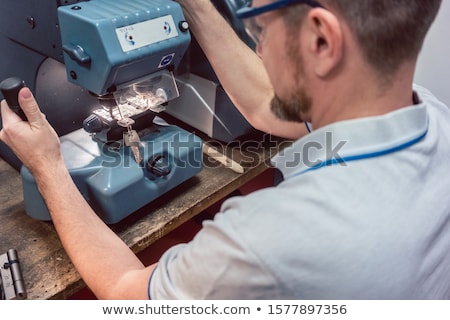 Stok fotoğraf: Locksmith Cutting Key With His Machine