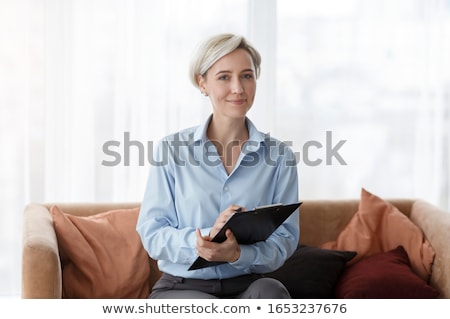 Foto d'archivio: Portrait Of Doctor With Health Record On White Background