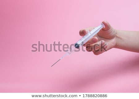 ストックフォト: Hand Holding Syringe Filled With Red Liquid
