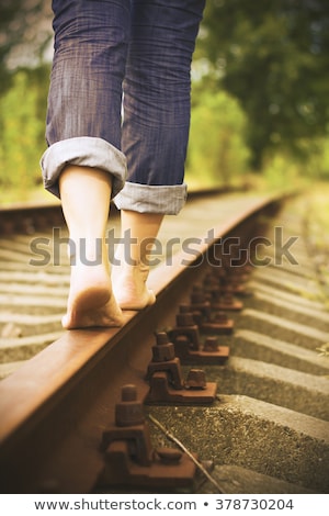 Stok fotoğraf: Barefoot Girl Goes By Rail