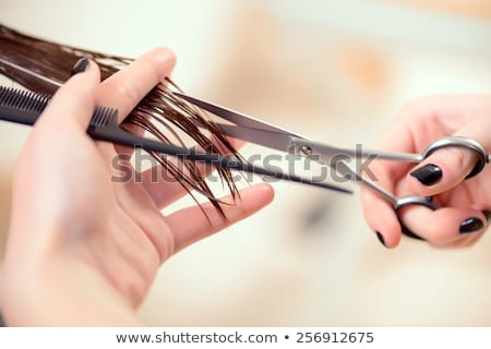 ストックフォト: Smiling Beautiful Woman Cutting Splitting Ends Of Hair With Scissors