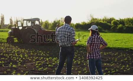 [[stock_photo]]: Female Farmer Looking At The Sun On The Horizon