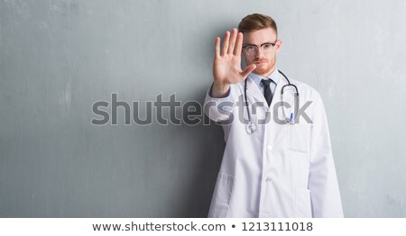 Foto stock: Caucasian Doctor Showing Stop Hand Gesture