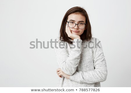 Stok fotoğraf: Pensive Teenage Girl In Eyeglasses Holding Hand On Chin And Looking Up Isolated On White