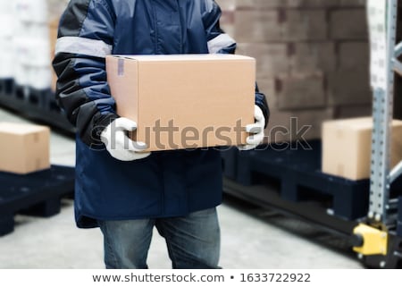 Stock fotó: Worker Carrying Loader With Goods At Warehouse