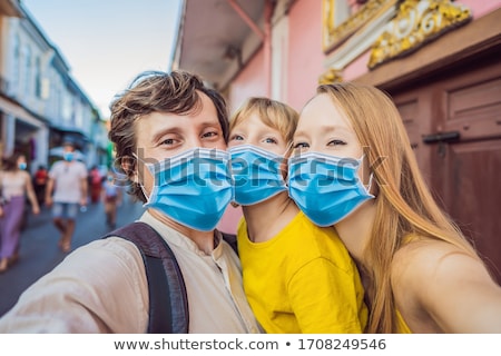 Foto stock: Mom Dad And Son Tourists On The Street In The Portugese Style Romani In Phuket Town Also Called Ch