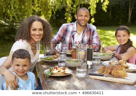 Сток-фото: Front View Of A Happy African American Family Having Food At Dining Table In A Comfortable Home