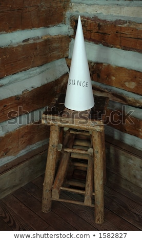 [[stock_photo]]: Old Dunce Cap On Stool