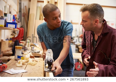 Stock photo: Craftsman And Young Apprentice Working Together