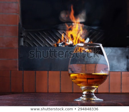 Stock photo: Two Glasses Of Cognac On The Old Brick Fireplace