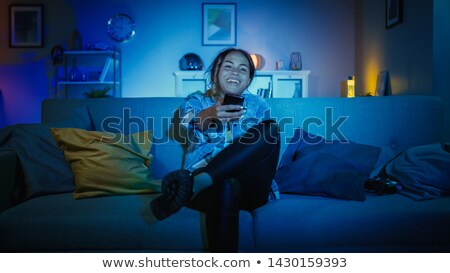 Stok fotoğraf: Woman Holding Different Remote Controls