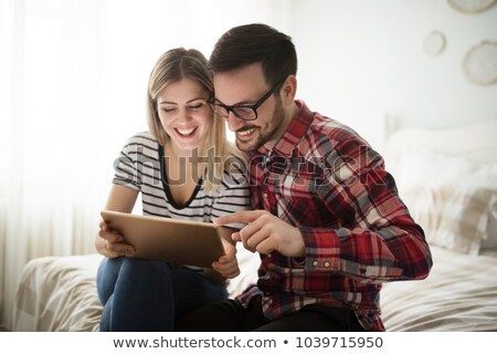 Foto stock: Handsome Man Using A Digital Tablet In Bed