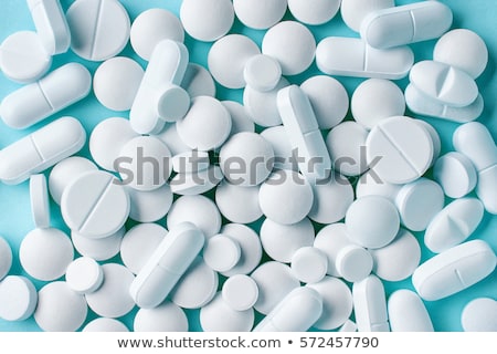 Foto d'archivio: White Pills On Blue Background