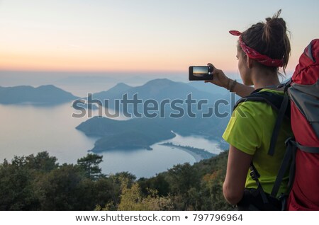 Foto stock: Woman With Backpack And Camera Over Mountains