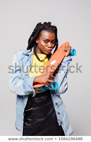 [[stock_photo]]: Image Of Skater Girl 20s Smiling And Holding Skateboard Isolate