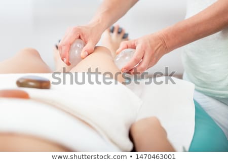 Stockfoto: Woman Receiving Thigh Massage With Stone