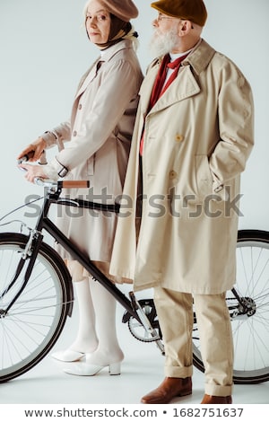 Stock photo: Senior Woman On The Side Of A Bike In Studio White Background