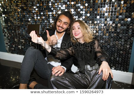 Stock photo: Cheerful Young Well Dressed Couple Making Selfie At Party In The Night Club