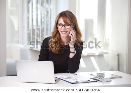 Foto d'archivio: Brunette With Laptop Making Telephone Call