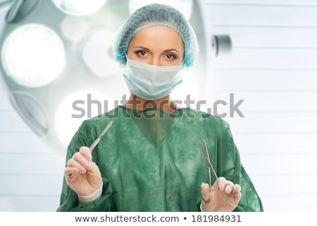 Stock fotó: Young Woman Doctor With Surgery Scalpel And Scissors