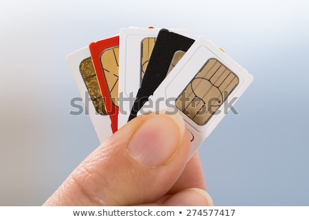 Stock photo: Finger Holding Sim Card