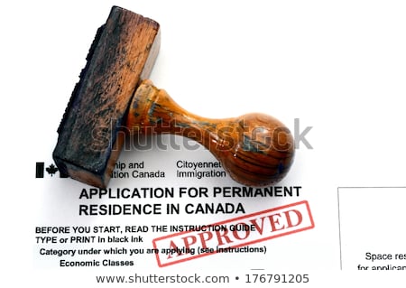 Stock photo: Wooden Rubber Stamp On Canadian Passport