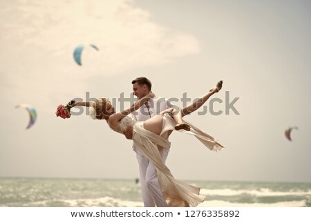 Zdjęcia stock: Smiling Woman Standing And Whirling On The Beach