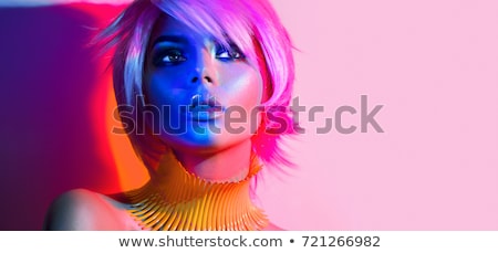 Foto stock: Beautiful Girl With Bright Vivid Purple And Green Make Up