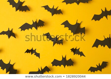 Foto d'archivio: Fun Cemetery - Halloween Orange Background With Blank Black Sale Label And Bats Flock Mock Up Ver
