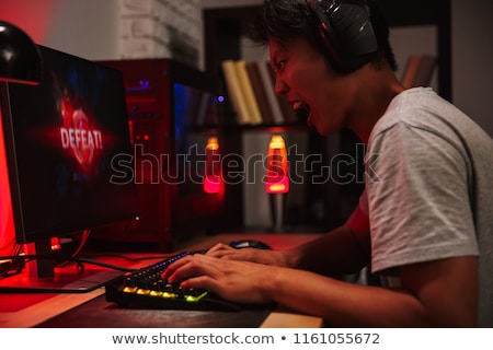 Stock fotó: Portrait Of Asian Tense Angry Gamer Boy Losing While Playing Vid