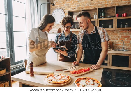 Stock fotó: Happy Friends With Tablet Pc In Kitchen