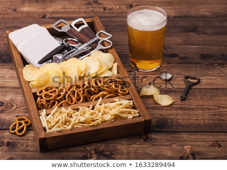 [[stock_photo]]: Glass Of Lager Beer With Potato Crisps Snack On Vintage Wooden Board On Black Background Beer And S