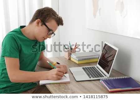 Stok fotoğraf: Teenager Doing Homework At The Table