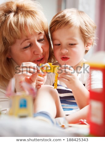 Grandmother Helping Her Grandson With A Puzzle Stock fotó © d13