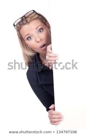 Stock photo: Blond Woman Holding The Side Of A Blank Sign Board