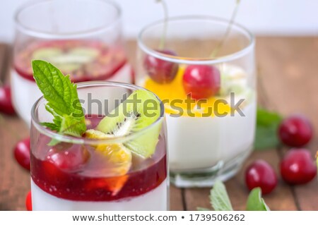 Stock photo: Vanilla Panna Cotta With Berry Sauce And Spring Flower