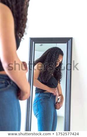 Foto stock: Young Woman In Black Tight Jeans