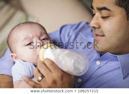 Stock fotó: Happy Hispanic Father Bottle Feeding His Mixed Race Son