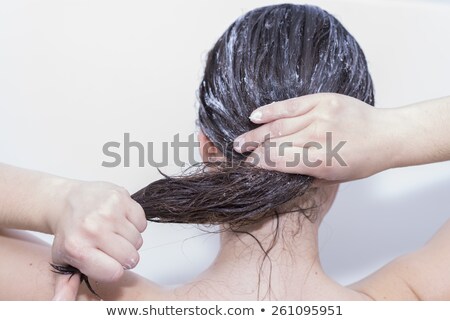 Stock fotó: Young Woman Soaping Her Hair With Bodyhair Care Products