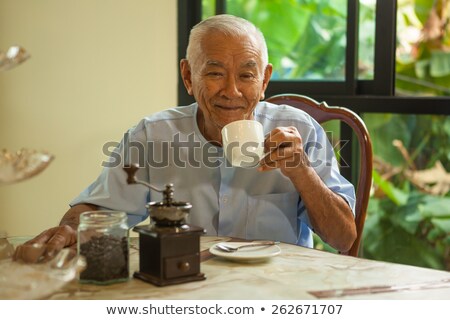 Stok fotoğraf: Asian Senior Man With Vintage Coffee Grinder