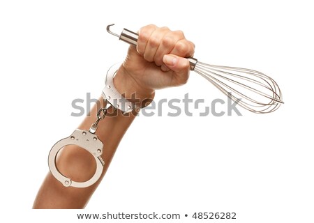 Stock photo: Woman Holding Egg Beater In The Air Isolated On White