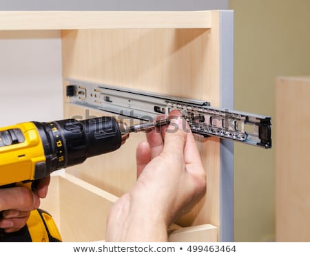 Stockfoto: Woan Assembling Furniture At Home Hand With Screwdriver