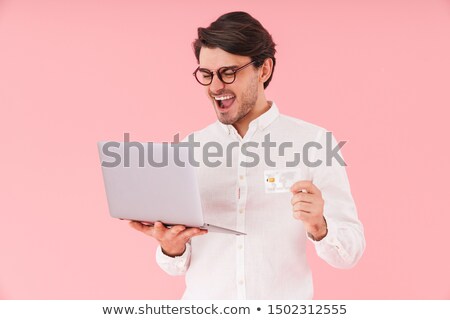 Foto stock: Image Of Happy Man In White Shirt Holding Credit Card And Smartp