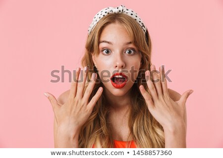 Zdjęcia stock: Beautiful Young Emotional Woman Posing Isolated Over Pink Background Showing Copyspace